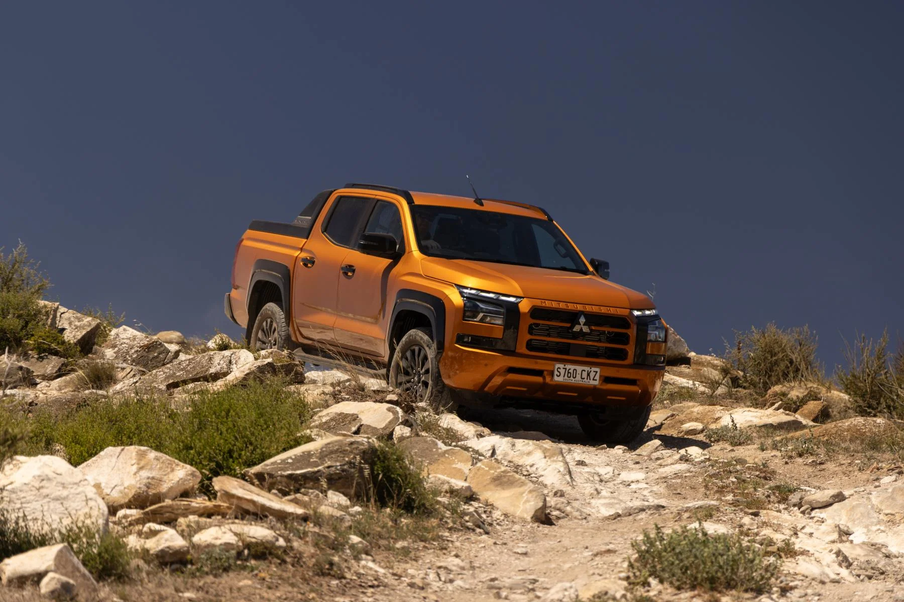 2024 Mitsubishi Triton GSR Yambuki Orange driving off road 1