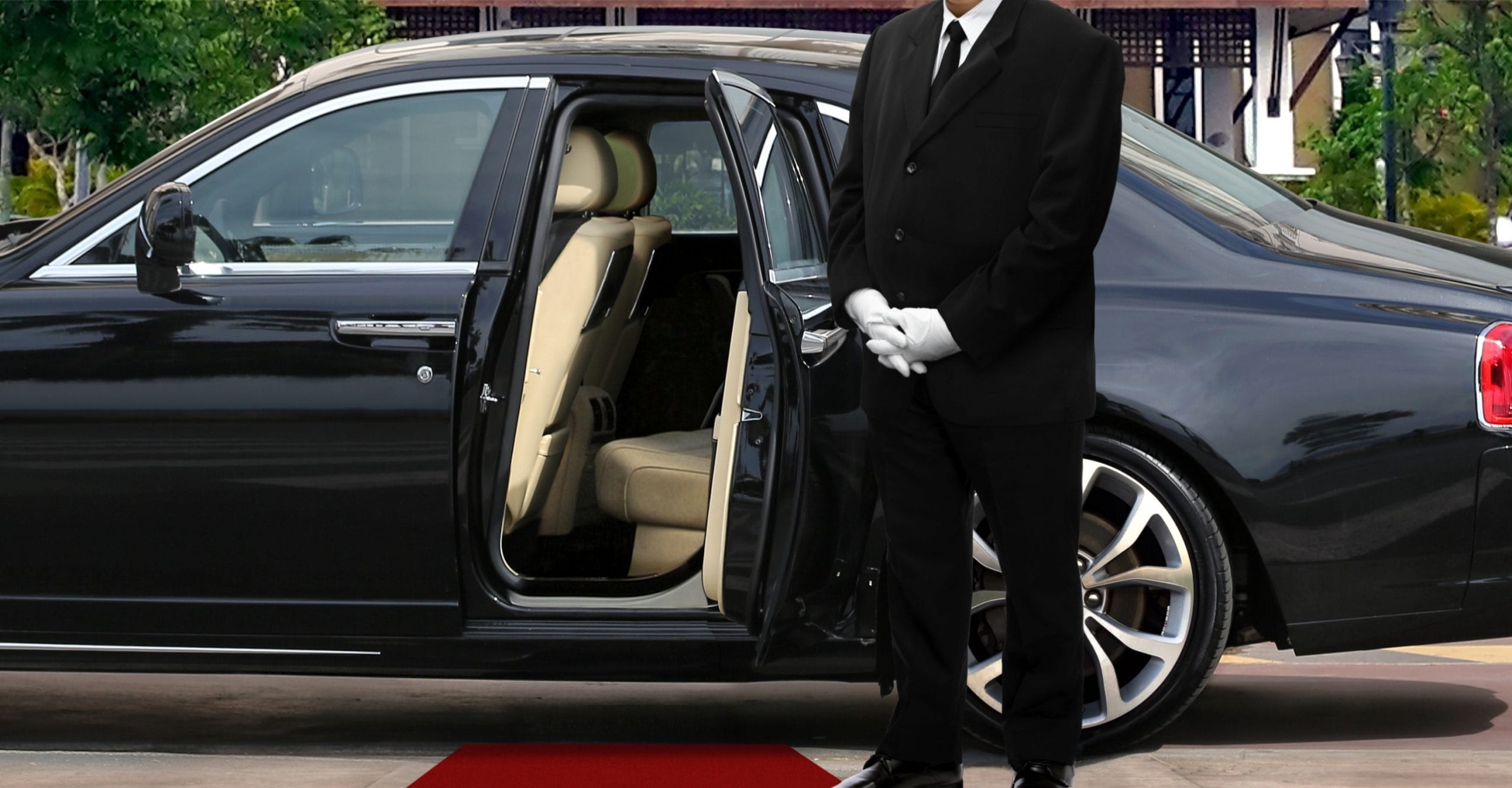Limo,Driver,Standing,Next,To,Opened,Car,Door,With,Red