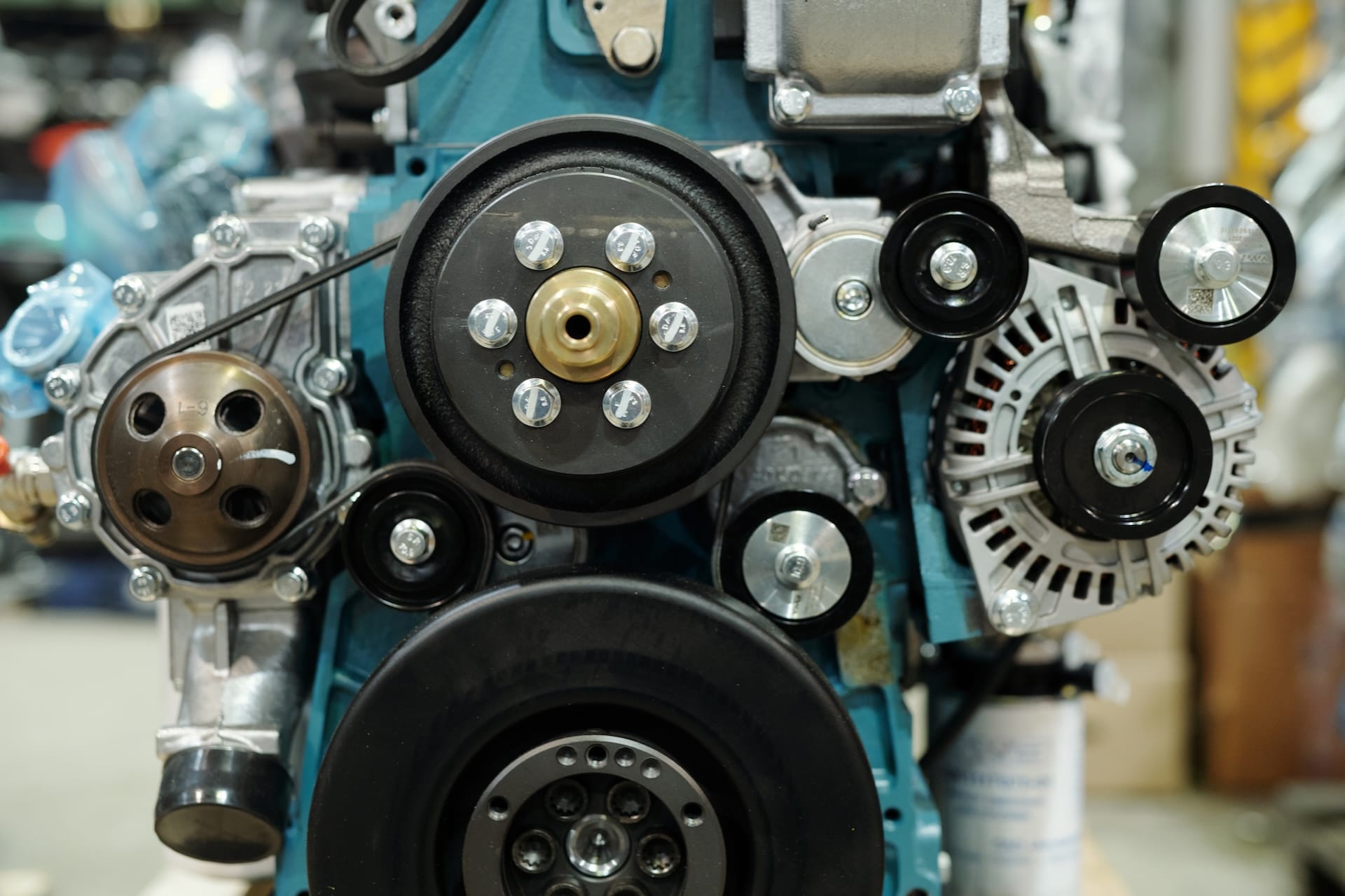 Close-up of working engine of huge industrial machine with rotating shafts inside distribution warehouse or workshop